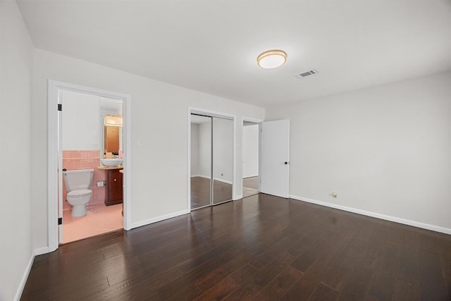 3518 Lakeland Dr, Austin, TX 78731 - unfurnished bedroom with wood finished floors, a closet, and connected bathroom