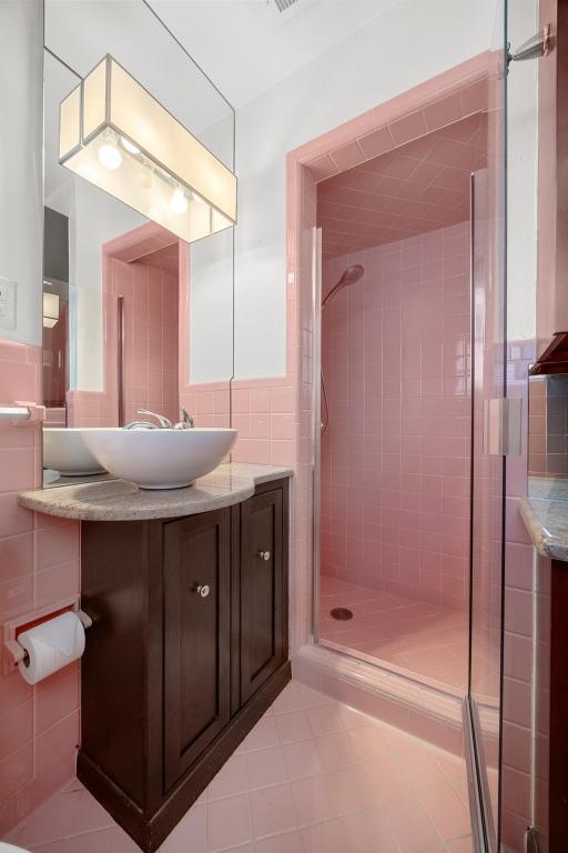 3518 Lakeland Dr, Austin, TX 78731 - full bath with tile walls, vanity, a stall shower, and tile patterned floors