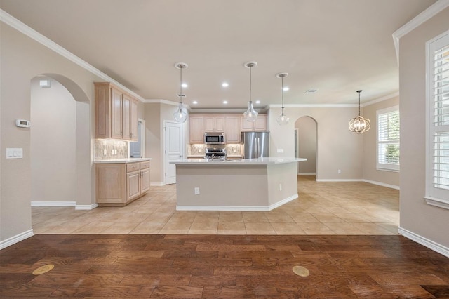 811 River Walk Trl, Georgetown, TX 78633 - kitchen with stainless steel appliances, arched walkways, backsplash, light countertops, and recessed lighting
