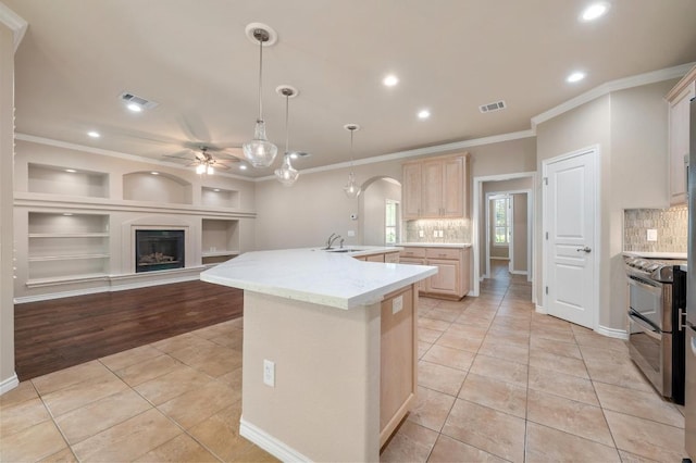 811 River Walk Trl, Georgetown, TX 78633 - kitchen featuring range with two ovens, light brown cabinets, light tile patterned floors, ceiling fan, and ornamental molding