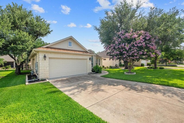 811 River Walk Trl, Georgetown, TX 78633 - view of front of house featuring driveway, a front lawn, a garage, and stone siding