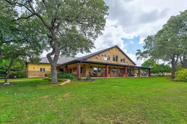 811 River Walk Trl, Georgetown, TX 78633 - back of house featuring stone siding, a yard, a porch, and a standing seam roof