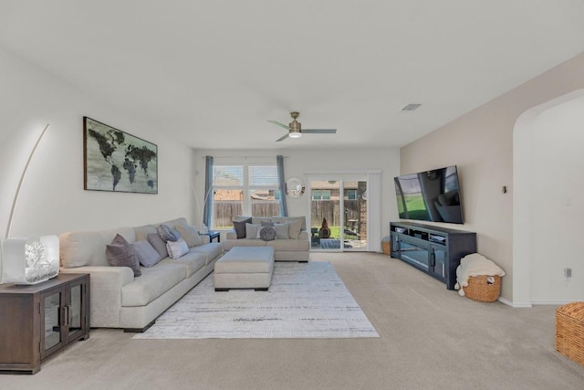 136 Everglades Ave, Taylor, TX 76574 - living room with arched walkways, light colored carpet, and ceiling fan