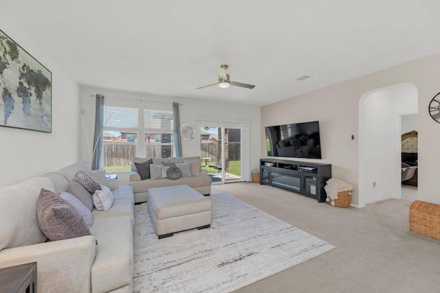 136 Everglades Ave, Taylor, TX 76574 - living room featuring carpet flooring, a ceiling fan, and arched walkways