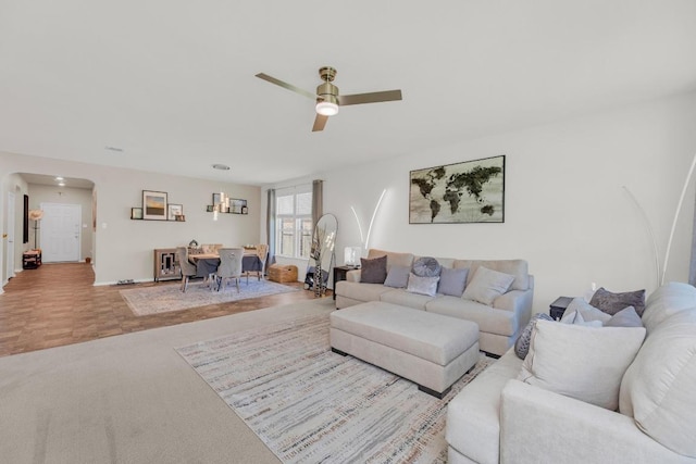136 Everglades Ave, Taylor, TX 76574 - carpeted living area featuring arched walkways and a ceiling fan