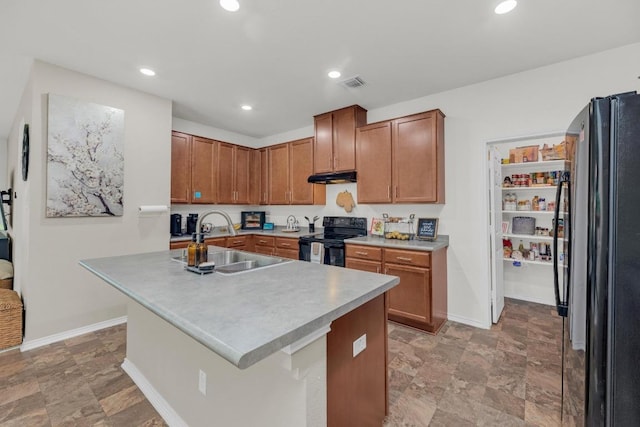 136 Everglades Ave, Taylor, TX 76574 - kitchen featuring electric range, freestanding refrigerator, under cabinet range hood, recessed lighting, and stone finish flooring