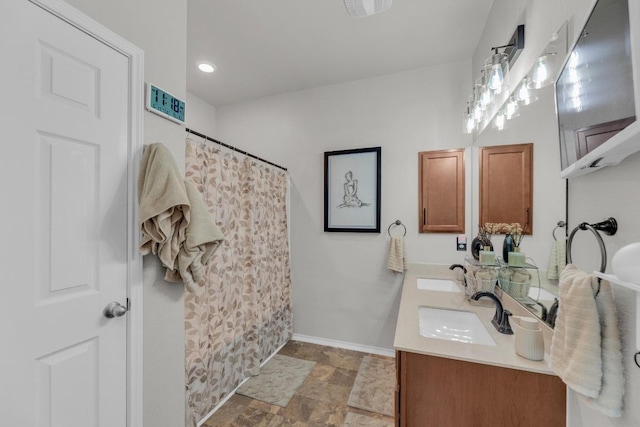 136 Everglades Ave, Taylor, TX 76574 - bathroom featuring stone finish flooring, double vanity, and curtained shower
