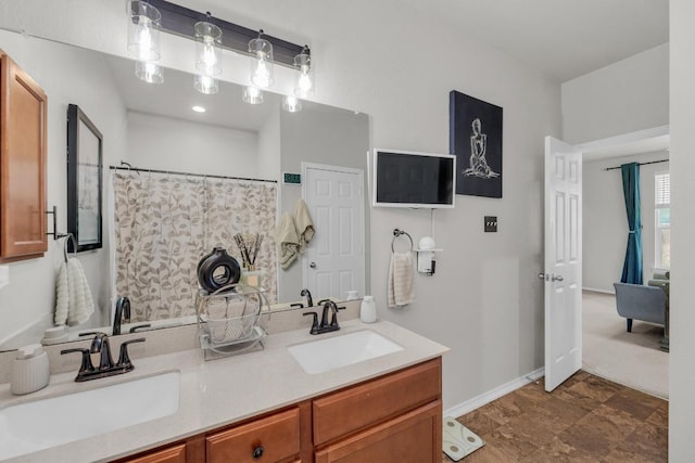 136 Everglades Ave, Taylor, TX 76574 - bathroom with double vanity and baseboards