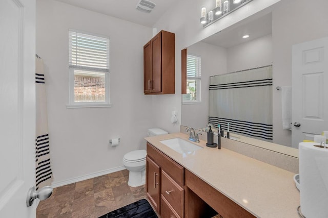 136 Everglades Ave, Taylor, TX 76574 - full bathroom featuring vanity, a shower with shower curtain, and stone finish flooring