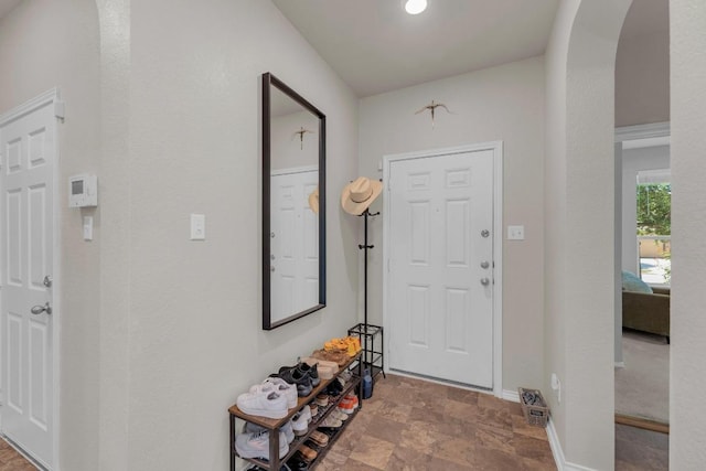 136 Everglades Ave, Taylor, TX 76574 - foyer with stone finish flooring and arched walkways