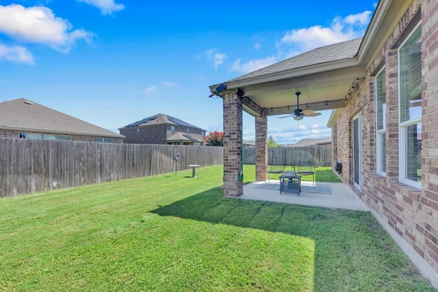 136 Everglades Ave, Taylor, TX 76574 - fenced backyard with ceiling fan and a patio area
