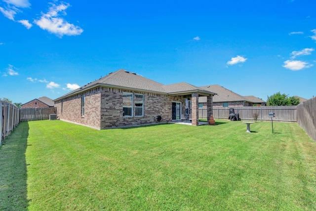 136 Everglades Ave, Taylor, TX 76574 - back of property with brick siding and a fenced backyard