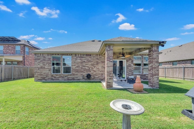 136 Everglades Ave, Taylor, TX 76574 - rear view of property with brick siding, a fenced backyard, a patio, and a shingled roof