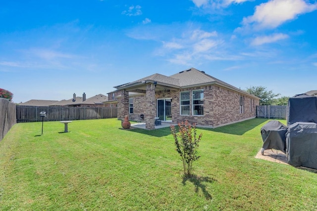 136 Everglades Ave, Taylor, TX 76574 - rear view of house featuring brick siding, a fenced backyard, and a patio