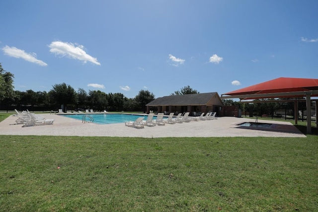 136 Everglades Ave, Taylor, TX 76574 - community pool featuring a community hot tub, a patio area, and a yard