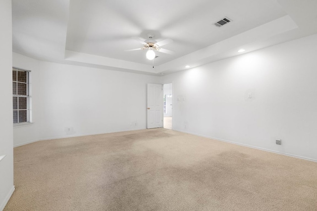 4917 Flaming Oak Cv, Austin, TX 78749 - spare room with a raised ceiling, a ceiling fan, carpet, and recessed lighting