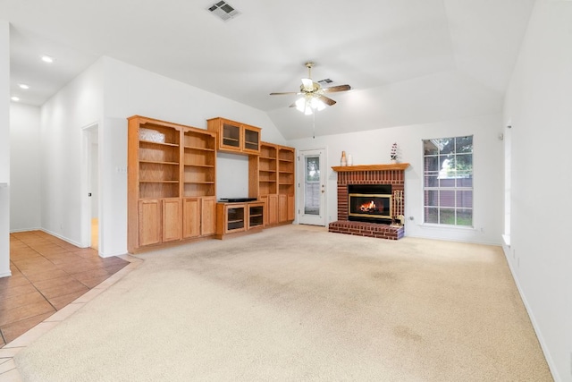 4917 Flaming Oak Cv, Austin, TX 78749 - unfurnished living room featuring a fireplace, a ceiling fan, lofted ceiling, light carpet, and light tile patterned floors