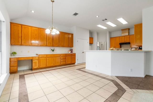 4917 Flaming Oak Cv, Austin, TX 78749 - kitchen featuring light tile patterned flooring, brown cabinetry, light countertops, a chandelier, and recessed lighting