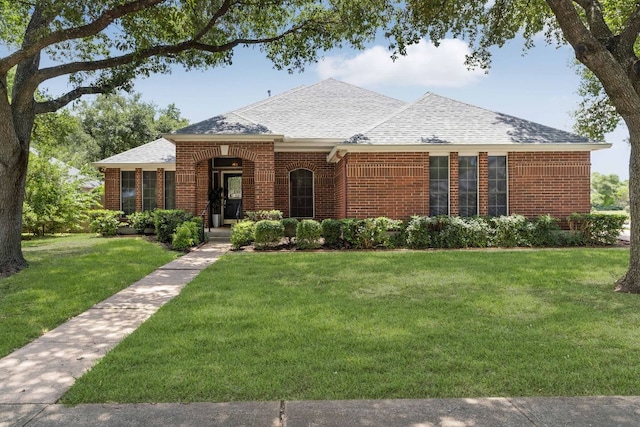 4917 Flaming Oak Cv, Austin, TX 78749 - view of front facade featuring brick siding, roof with shingles, and a front yard