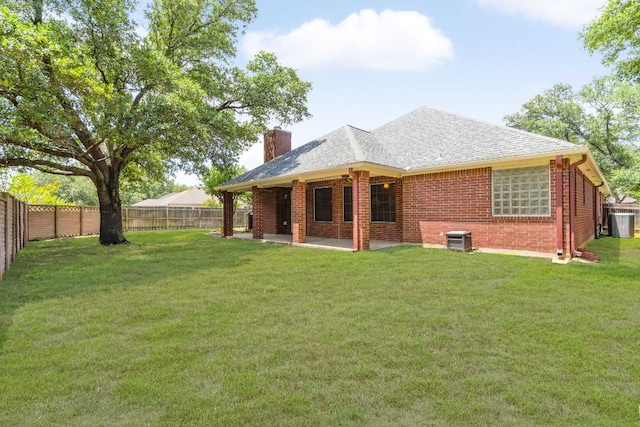 4917 Flaming Oak Cv, Austin, TX 78749 - rear view of property featuring brick siding, a chimney, a fenced backyard, a shingled roof, and a patio