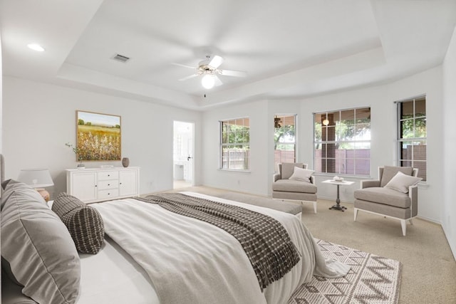 4917 Flaming Oak Cv, Austin, TX 78749 - bedroom featuring a raised ceiling, light carpet, and a ceiling fan