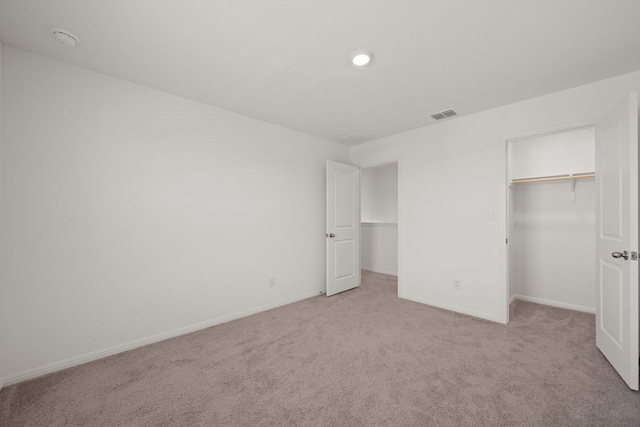 701 Redfish Ln, Hutto, TX 78634 - unfurnished bedroom with carpet, a closet, a walk in closet, and recessed lighting