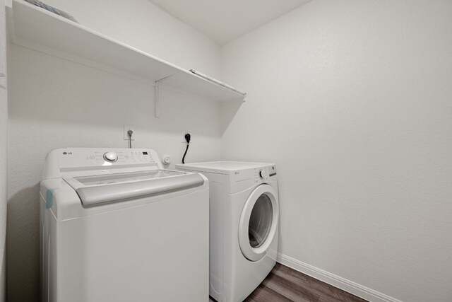 701 Redfish Ln, Hutto, TX 78634 - laundry area featuring washer and dryer and dark wood-style floors