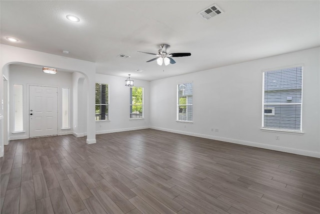 1102 Peyton Pl, Cedar Park, TX 78613 - unfurnished living room featuring arched walkways, ceiling fan, dark wood-style flooring, and recessed lighting