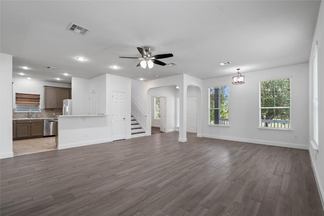 1102 Peyton Pl, Cedar Park, TX 78613 - unfurnished living room featuring arched walkways, wood finished floors, stairway, recessed lighting, and ceiling fan