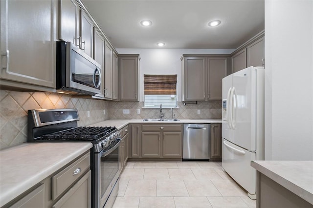 1102 Peyton Pl, Cedar Park, TX 78613 - kitchen featuring stainless steel appliances, gray cabinetry, tasteful backsplash, light countertops, and recessed lighting