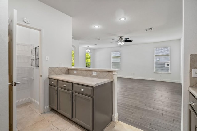 1102 Peyton Pl, Cedar Park, TX 78613 - kitchen with ceiling fan, a peninsula, gray cabinets, light countertops, and recessed lighting