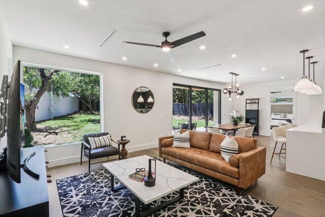 5700 Louise Ln, Austin, TX 78757 - living area with recessed lighting, wood finished floors, a chandelier, and a ceiling fan