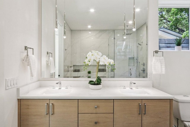 5700 Louise Ln, Austin, TX 78757 - bathroom with a marble finish shower, double vanity, and recessed lighting