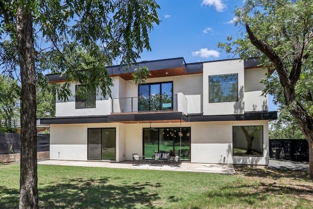 5700 Louise Ln, Austin, TX 78757 - back of house featuring a balcony, stucco siding, and a patio area