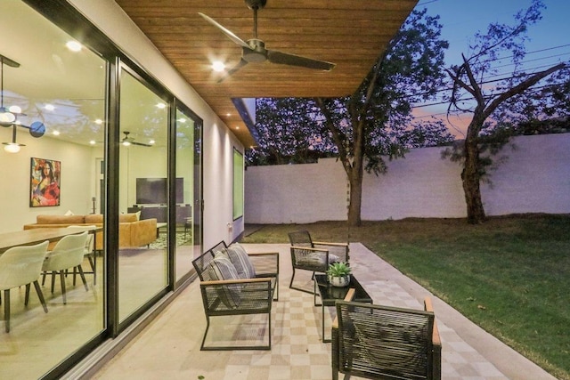 5700 Louise Ln, Austin, TX 78757 - patio terrace at dusk featuring a ceiling fan, an outdoor hangout area, and a patio area