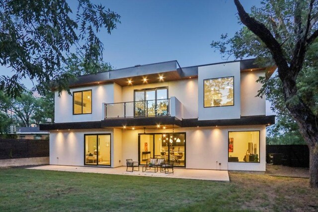 5700 Louise Ln, Austin, TX 78757 - rear view of house with a balcony, a patio area, and stucco siding