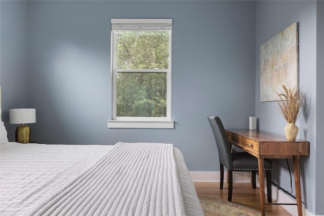 7606 Providence Ave Unit B, Austin, TX 78752 - bedroom featuring wood finished floors and multiple windows