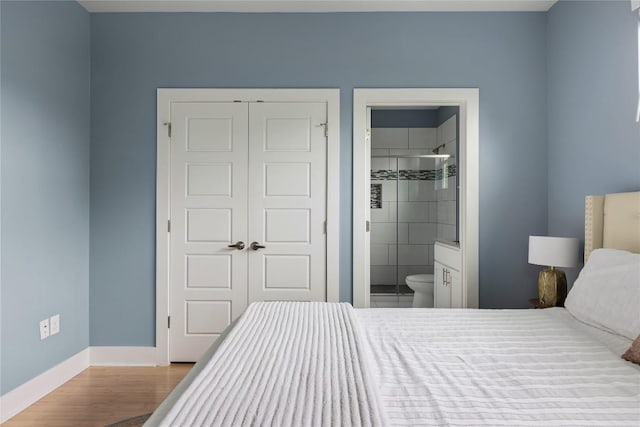 7606 Providence Ave Unit B, Austin, TX 78752 - bedroom with wood finished floors and connected bathroom