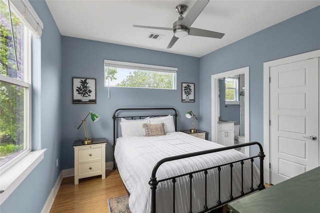 7606 Providence Ave Unit B, Austin, TX 78752 - bedroom featuring wood finished floors, ensuite bathroom, and a ceiling fan