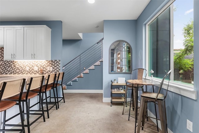 7606 Providence Ave Unit B, Austin, TX 78752 - dining room featuring concrete floors and stairs