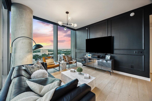 44 E Ave Unit 1607, Austin, TX 78701 - living room with light wood-type flooring, floor to ceiling windows, a chandelier, and a decorative wall