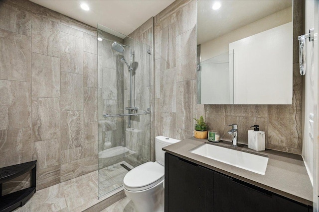 44 E Ave Unit 1607, Austin, TX 78701 - bathroom featuring walk in shower, vanity, tile walls, and recessed lighting