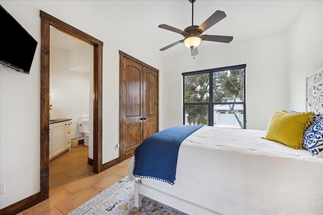 bedroom with light tile patterned floors, ensuite bath, ceiling fan, and a closet