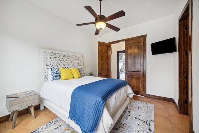 bedroom featuring light tile patterned flooring and ceiling fan