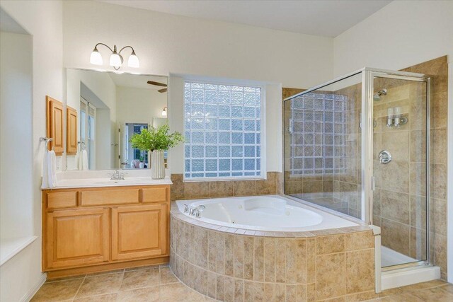 17120 Northlake Hills Dr, Jonestown, TX 78645 - full bathroom featuring a garden tub, a stall shower, vanity, tile patterned floors, and ceiling fan