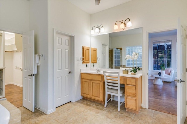 17120 Northlake Hills Dr, Jonestown, TX 78645 - full bath with vanity, a towering ceiling, and tile patterned floors