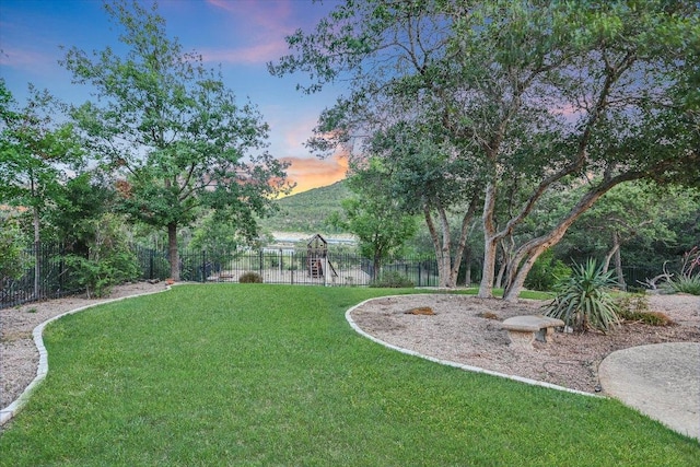 17120 Northlake Hills Dr, Jonestown, TX 78645 - yard at dusk with a playground