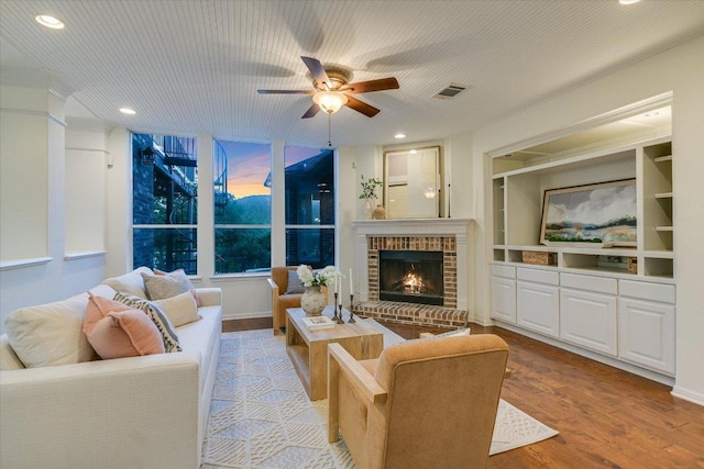 17120 Northlake Hills Dr, Jonestown, TX 78645 - living room featuring ceiling fan, wood finished floors, a fireplace, recessed lighting, and built in features