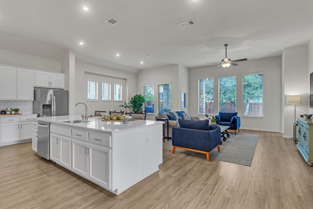 7901 Sunrise Ravine Pass, Lago Vista, TX 78645 - kitchen with appliances with stainless steel finishes, white cabinetry, light countertops, light wood finished floors, and a ceiling fan