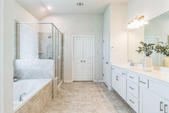 7901 Sunrise Ravine Pass, Lago Vista, TX 78645 - full bathroom with double vanity, a bath, a shower stall, and vaulted ceiling